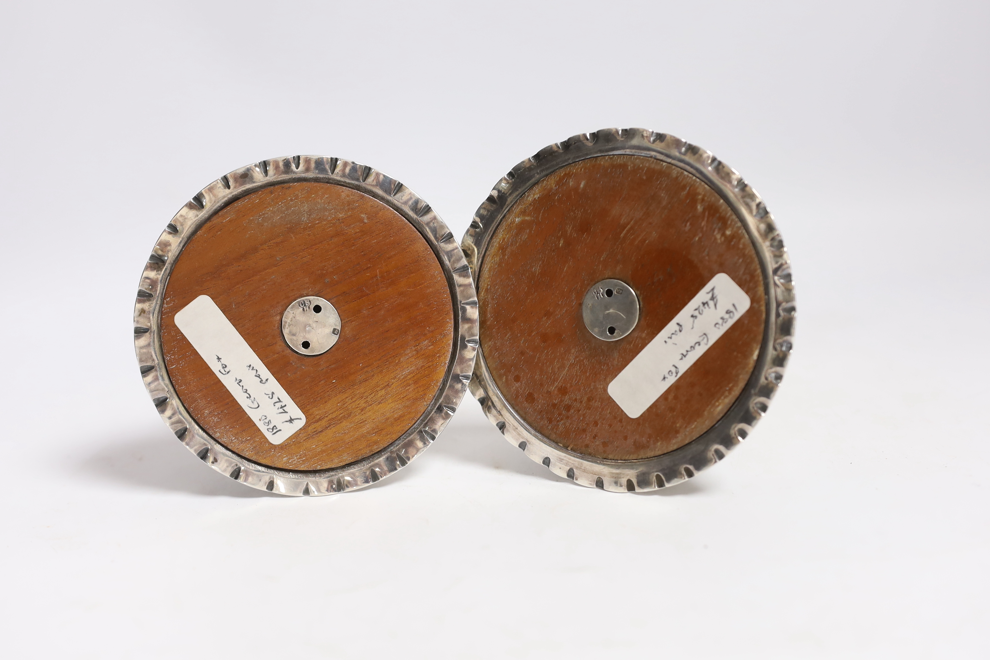 A matched pair of Carolean style silver dwarf candlesticks, London, 1880 & 1885, makers mark on one for George Fox, silver disc to base marked for Charles Stuart Harris, height 12.3cm, weighted.
